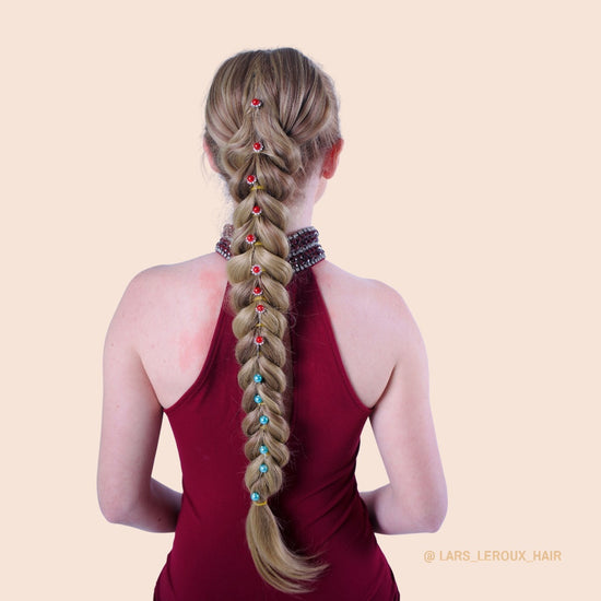 Decorative pins added along the full length of a Topaz french braid ponytail from Lars Leroux Hair